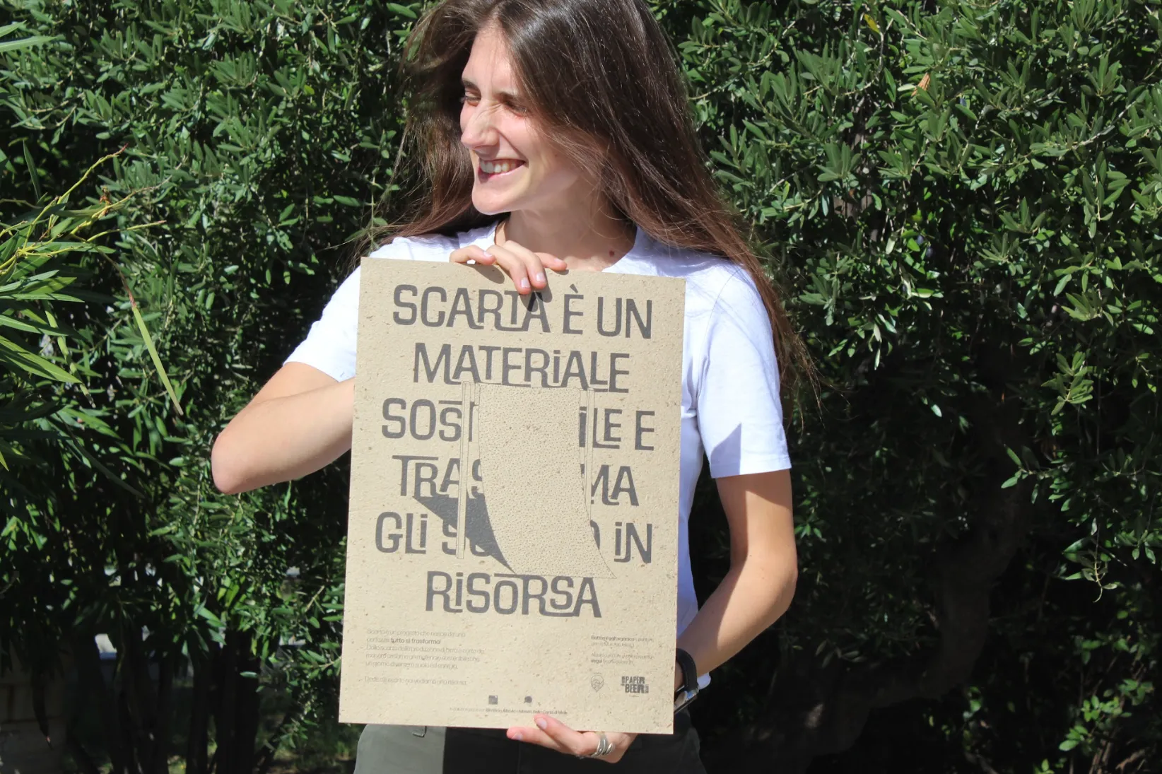 Sofia holding a poster printed on Scarta paper